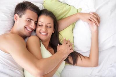 Chico feliz y chica en la cama
